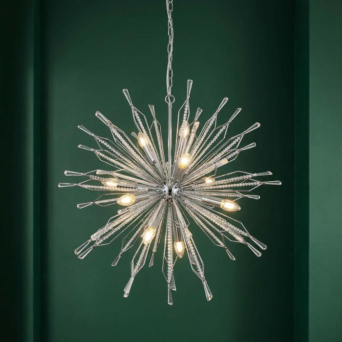 Starburst 10 light chrome and crystal glass ceiling pendant illuminated against a dark green wall.