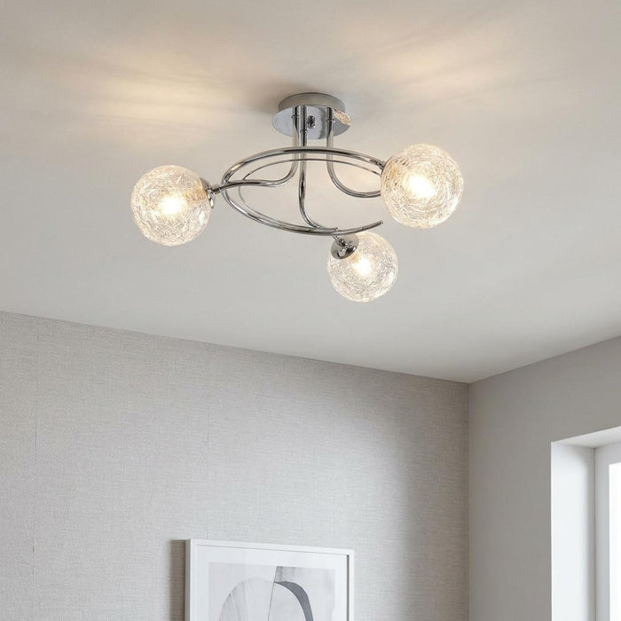 Modern Tabia 3-light chrome flush ceiling light with glowing textured glass globes on a white ceiling.