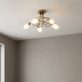 Tara five light antique brass flush ceiling fixture with frosted glass shades and decorative curved arms.