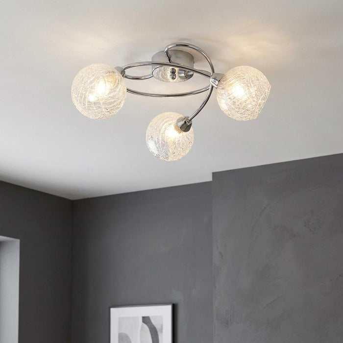 Tarn 3 Light Chrome Flush Ceiling Light with illuminated textured glass globes on curved arms.