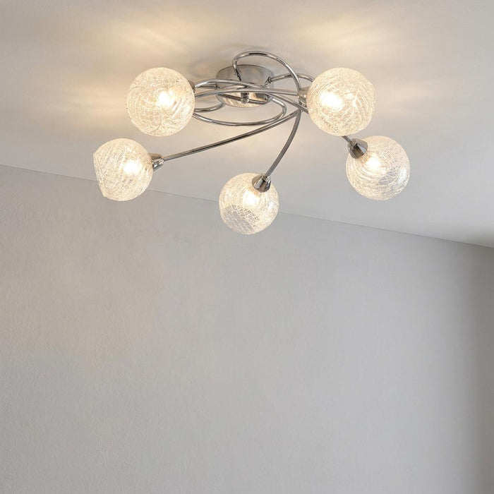 Tarn 5-light chrome flush ceiling light with crackled glass globe shades mounted on a white ceiling.