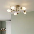 Tawa 5-light antique brass flush ceiling fixture with elegant curved arms and opal glass shades.