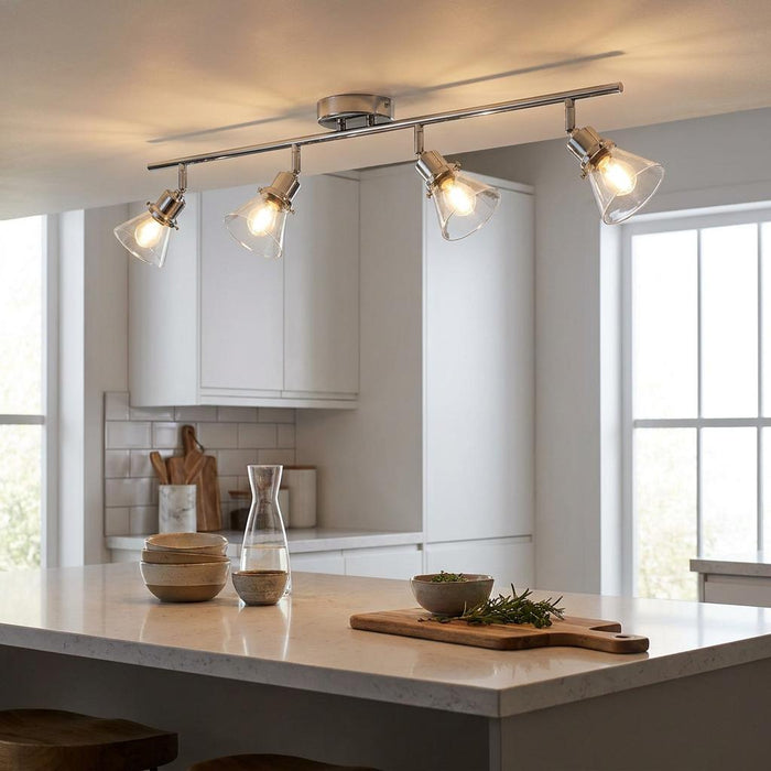Torne 4 bar chrome and glass spotlight mounted on a kitchen ceiling above a white island.