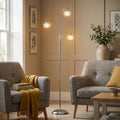 Toulon polished chrome floor lamp with three decorative crystal shades in a neutral living room setting.