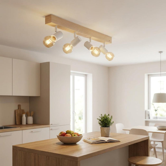 Four-light wood and white spotlight bar mounted on a kitchen ceiling above a wooden kitchen island.