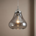 Turua Chrome Ceiling Lantern featuring a smoked glass bell shade and a visible glowing filament bulb.