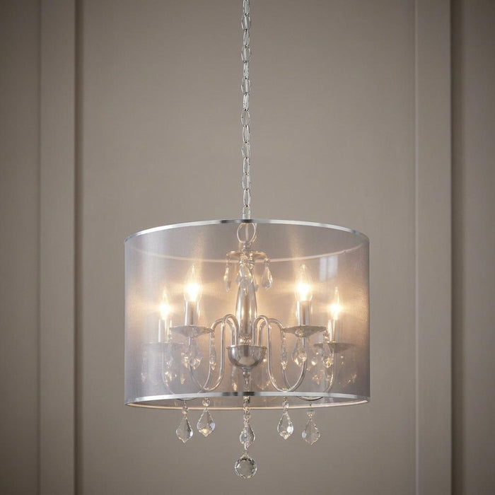 Venetian 5 light chrome chandelier with crystal droplets and a semi-sheer silver drum shade hanging from a chain.