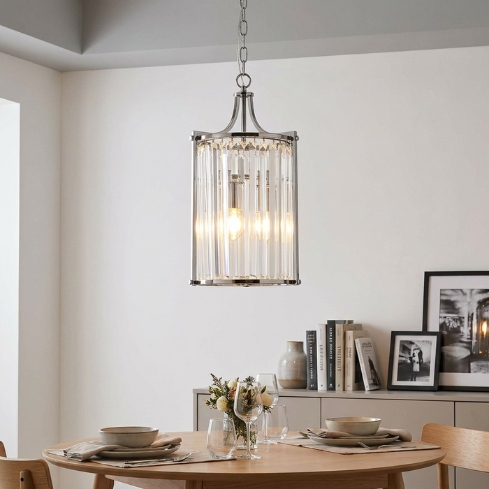 Victoria 2 Light Chrome & Crystal Glass Ceiling Pendant illuminating a modern dining room and wooden table.