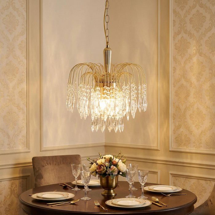 A Waterfall 3 Light Gold Clear Crystal Ceiling Pendant hangs elegantly over a set dining table in a classic room.