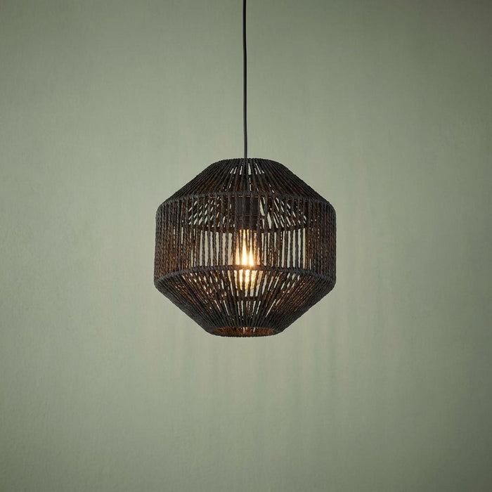 Black wicker rope effect ceiling pendant light with a glowing bulb against a sage green wall.
